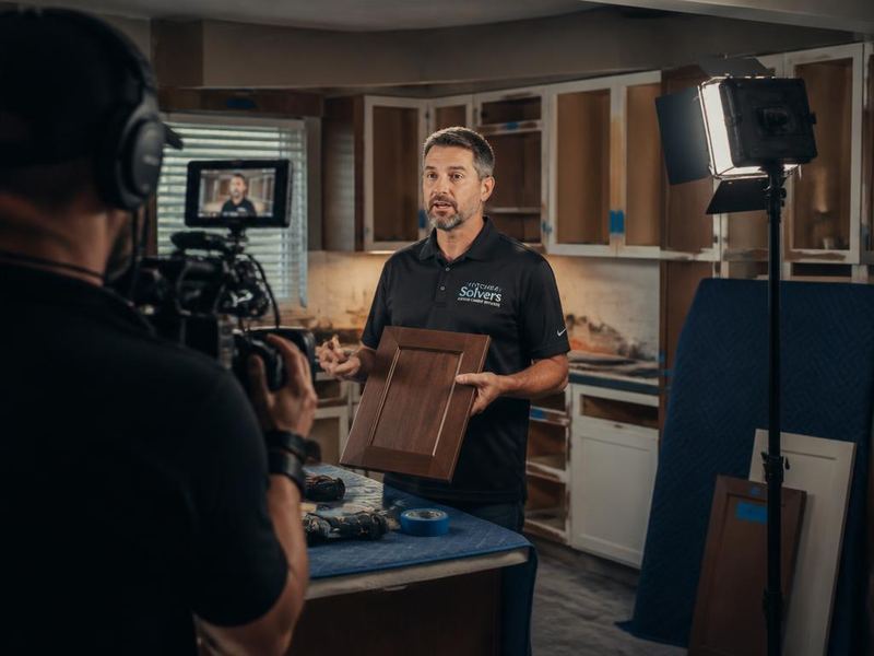 Videographer filming a cabinet refacing contractor in a kitchen worksite